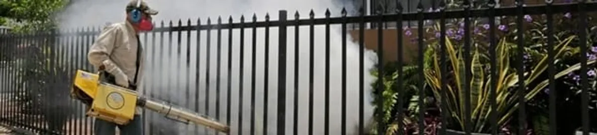 Mosquito control technician fogging a yard perimeter for mosquito reduction in Lakeland, FL